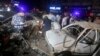 Pakistani investigators examine the site of bomb explosion, in Karachi, Pakistan, on May 12, 2022.