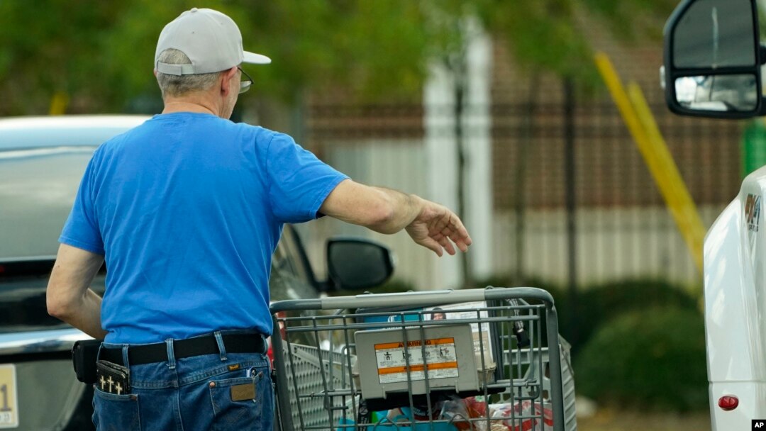 A shopper removes his purchases from his cart in Jackson, Miss., Wednesday, Oct. 12, 2022.