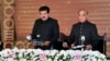 In this photo released by Press Information Department, acting President of Pakistan Sadiq Sanjrani, left, administers the oath of office to newly elected Pakistani Prime Minister Shahbaz Sharif at Presidential Palace in Islamabad, April 11, 2022