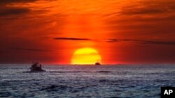 FILE - Lobster fishermen work at sunrise in the Atlantic Ocean, Sept. 8, 2022, off of Kennebunkport, Maine. Scientists, lawyers and government officials are gathered in Jamaica the week of Nov. 1, 2022 to debate deep sea mining