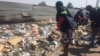Bulawayo Metropolitan Minister and other people cleaning streets on Monday. 