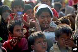A rescued migrant weeps upon arrival Simpang Tiga, Aceh province, Indonesia, Wednesday, May 20, 2015.