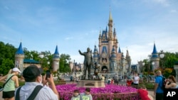FILE - People visit Magic Kingdom Park at Walt Disney World Resort in Lake Buena Vista, Florida, on April 18, 2022. 