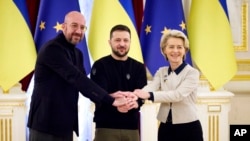 Ukrainian President Volodymyr Zelenskyy, center, European Commission President Ursula von der Leyen, right, and European Council President Charles Michel shake hands during the EU-Ukraine summit in Kyiv, Ukraine, Friday, Feb. 3, 2023. (Ukrainian Presidential Press Office via AP)