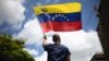 FILE - A man waves a Venezuelan flag in Caracas on Aug. 17, 2024. 
