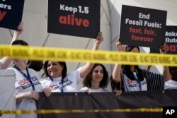 FILE - Activists protest against fossil fuels at the COP28 U.N. Climate Summit on Dec. 5, 2023, in Dubai, United Arab Emirates.