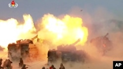FILE - This image broadcast by North Korea's KRT on April 26, 2017, shows a "combined fire demonstration" in Wonsan, North Korea. North Korea is apparently moving to sell millions of rockets and artillery shells – many of them likely from old stock – to R