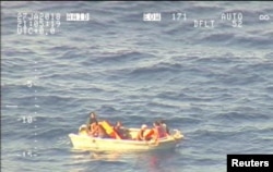 A handout photo supplied by the New Zealand Defence Force shows survivors from a ferry that sunk floating in a boat in the sea near the South Pacific nation of Kiribati, Jan. 27, 2018.