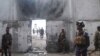 Somali security forces stand outside the mayor's office following a blast in Mogadishu, Jan. 22, 2023.