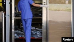 FILE - Corpses are seen at a hospital’s bereavement room, as COVID-19 cases surge in Hong Kong, China, March 3, 2022.