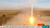 Potongan gambar dari video yang disiarkan oleh televisi pemerintah Iran menunjukkan peluncuran roket oleh Pasukan Revolusi Iran di timur laut gurun Shahroud, Iran, pada 8 Maret 2022. Roket tersebut membawa satelit Noor-2 . (Foto: Iranian state television via AP)