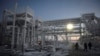 FILE - People walk through the Utrenneye field, the resource base for Novatek's Arctic LNG 2 project, located in the Gydan Peninsula on the Kara Sea shore line in the Arctic circle, some 2,500 km from Moscow, Nov. 30, 2021.