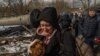 A woman cries as she escapes Irpin, Ukraine, March 8, 2022. (Yan Boechat/VOA) 