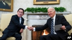 President Joe Biden shakes hands with Japanese Prime Minister Fumio Kishida as they meet in the Oval Office of the White House, Friday, Jan. 13, 2023, in Washington. (AP Photo/Evan Vucci)