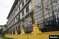 FILE - Barbed wire fences are seen outside a shuttered Great Wall Park compound where Cambodian authorities said they had recovered evidence of human trafficking, kidnapping and torture during raids on suspected cybercrime compounds in Sihanoukville, Cambodia, September 21, 2022.