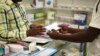 FILE — A man buys a face mask at a pharmacy in Kitwe, Zambia, Feb. 6, 2020. Amid the pandemic, Zambia faced a deadline to clear debt owed to external investors. On Saturday, the IMF announced progress.