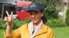 FILE - Pakistani mountaineer Samina Baig flashes a victory sign while she poses for a photograph outside a hotel, in Skardu, Pakistan, June 17, 2021.