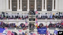 FILE - Insurrectionists loyal to President Donald Trump breach the Capitol in Washington, Jan. 6, 2021.