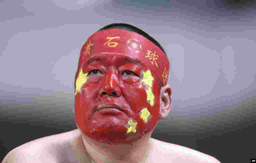 A supporter of the China national soccer team with his face painted in the China's national color during the soccer match against South Korea for the 2018 FIFA World Cup qualifier at Seoul World Cup Stadium in Seoul, South Korea.