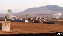 FILE - Smoke rises from bombardment amid battles between the Turkish-backed Syrian National Army faction and the Kurdish-led Syrian Democratic Forces at a position near the Tishrin Dam in the vicinity of Manbij, in the east of Syria's northern Aleppo province, Jan. 10, 2025.