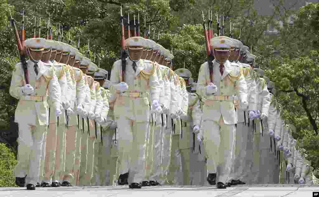 Members of an honor guard march during a preparation before Japanese Prime Minister Shinzo Abe reviews them in a ceremony prior to his meeting with high-ranked officers of the Japan Self-Defense Forces at the Defense Ministry in Tokyo.