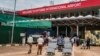 FILE - Passengers arriving on international flights leave the international arrivals lobby at Entebbe Airport in Uganda, March 3, 2020. 