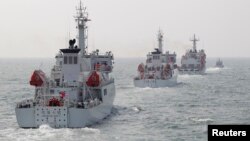 Taiwan Coast Guard patrol ships are seen during a drill held about 30 nautical miles northwest of the port of Kaohsiung, southern Taiwan, March 30, 2013. 