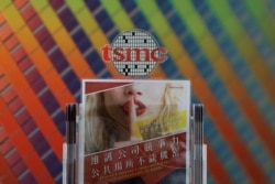 FILE - A leaflet that asks employees to protect the company's confidentiality is seen at a reception at the Taiwan Semiconductor Manufacturing Company, in Hsinchu, Taiwan, Aug. 31, 2018.