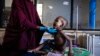 FILE - Ali Abdullahi Mohamed, a severely malnourished 27-month-old boy, is examined by a nurse for treatment in Banadir Maternity and Children Hospital in Mogadishu, Somalia, June 1, 2022. 