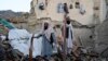 Afghan men sift through debris after an earthquake, in Gayan village, Paktika province, Afghanistan, June 23, 2022.