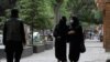 Afghan women walk on a street in Kabul, Afghanistan, May 9, 2022.