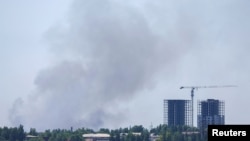 Smoke rises over the city following recent shelling in the course of Ukraine-Russia conflict in Donetsk, Ukraine, June 20, 2022. 