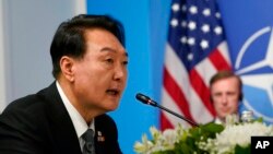 South Korea's President Yoon Suk Yeol speaks during a meeting with President Joe Biden and Japan's Prime Minister Fumio Kishida during the NATO summit in Madrid, Wednesday, June 29, 2022. (AP Photo/Susan Walsh)