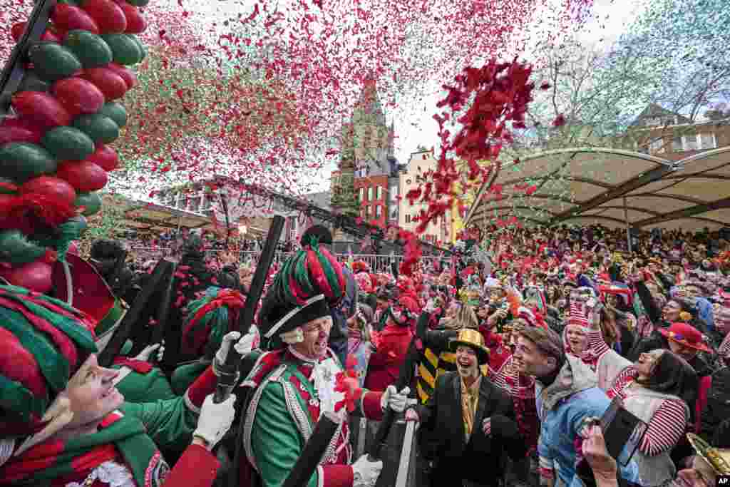 Para pengunjung merayakan dimulainya karnaval jalanan di Alter Markt (Pasar Lama) di Cologne, Jerman. (AP) 