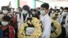 People carry a wreath as they attend the funeral of Khant Nyar Hein, a medical student who was shot and killed during the security force crackdown on anti-coup protesters in Yangon, Myanmar, March 16, 2021.