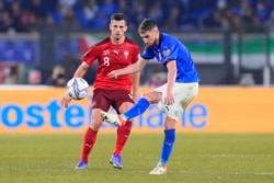 Jorginho na Italiya ya ba da kwallon yayin da Remo Freuler na Switzerland ya rufe shi a wasan neman gurbin shiga gasar cin kofin duniya na rukunin C na 2022 tsakanin Italiya da Switzerland a filin wasa na Olympics na Rome, Juma'a, 12 ga Nuwamba, 2021.