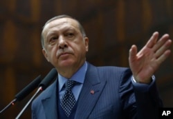FILE _ Turkey's President Recep Tayyip Erdogan addresses his supporters at the parliament in Ankara, Turkey, Nov. 28. 2017.