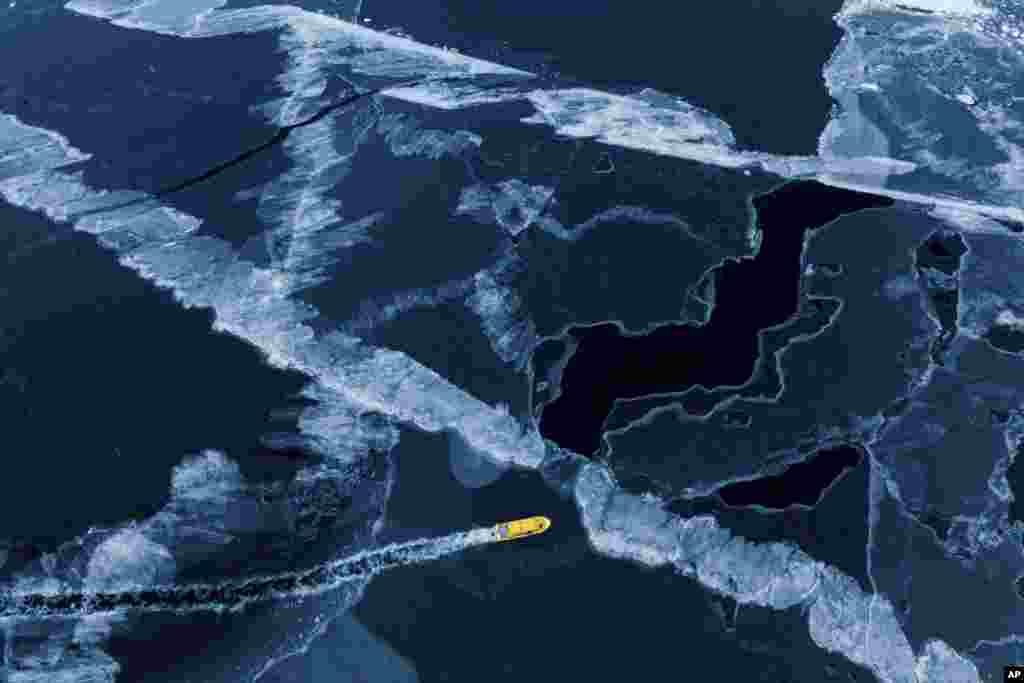 A boat rides though a frozen sea inlet outside of Nuuk, Greenland, March 6, 2025. 