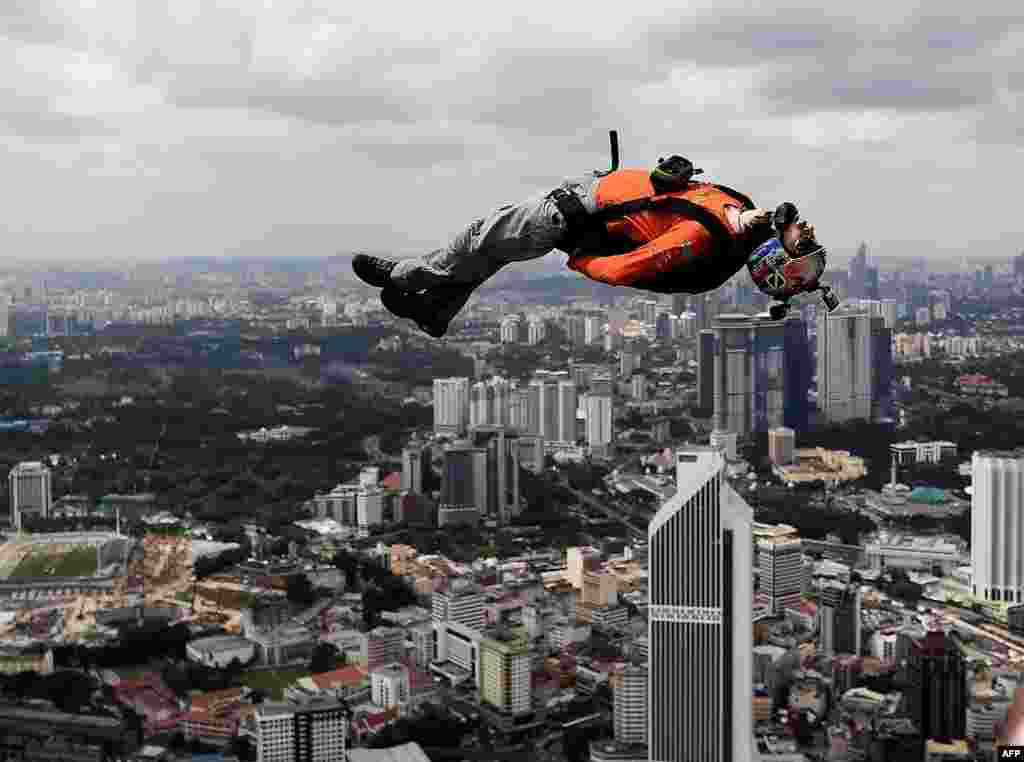 A base jumper leap from the 300-meter-high skydeck of Malaysia&#39;s landmark Kuala Lumpur Tower during the annual International KL Tower Base-Jump event.