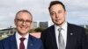 A handout photo taken and received on July 7, 2017, shows South Australia's Premier Jay Weatherill (L) and Tesla Motors CEO Elon Musk (R) at an announcement in Adelaide. AFP photo /South Australia Department of Premier and Cabinet.