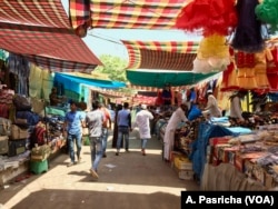 Despite the heat, shoppers throng a colorful market near an iconic Jama Masjid mosque in the Indian capital.