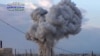 FILE - An image by Syrian activists purports to show smoke rising after a Russian airstrike hit buildings in the town of Latamna, near Hama in eastern Syria, Oct. 7, 2015.