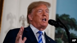 President Donald Trump delivers a statement on the Iran nuclear deal from the Diplomatic Reception Room of the White House, May 8, 2018, in Washington.