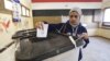 A woman casts her vote at a polling station during the second round of parliamentary elections in the Shubra area of Cairo, Nov. 22, 2015. 