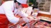 A staff member at a Taipei hyper market examines imported US beef, (File Photo). 