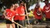 Mexican actress/singer Dulce Maria, far left, helps to build a children's playground at City of Lynwood Park, Aug. 29, 2012, in Lynwood, California.