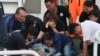 Family members cry around the body of Taiwanese fisherman Hung Shih-cheng after his boat, the Kuang Ta Hsing No. 28, arrived at Liuqiu port in Pingtung County, southern Taiwan, May 11, 2013. 