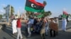 FILE - Protesters demonstrate against the U.N. draft agreement for a political settlement between the parallel governments in Libya, in Benghazi, Sept. 18, 2015. 