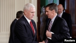 Vice President Mike Pence greets National Security Advisor Michael Flynn before Japanese Prime Minister Shinzo Abe and U.S. President Donald Trump arrive for their joint news conference at the White House in Washington, Feb. 10, 2017.