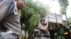 Indonesian police officers and soldiers carry one of the coffins prepared for the victims of a military helicopter which crashed in Poso, Central Sulawesi, at hospital in Jakarta, Indonesia, March 21, 2016. 